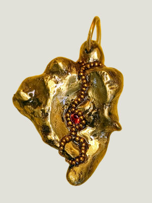 Recto pendentif pépite laiton fondue ornée de petites perles dorées et d'une grenat avec anneau en laiton